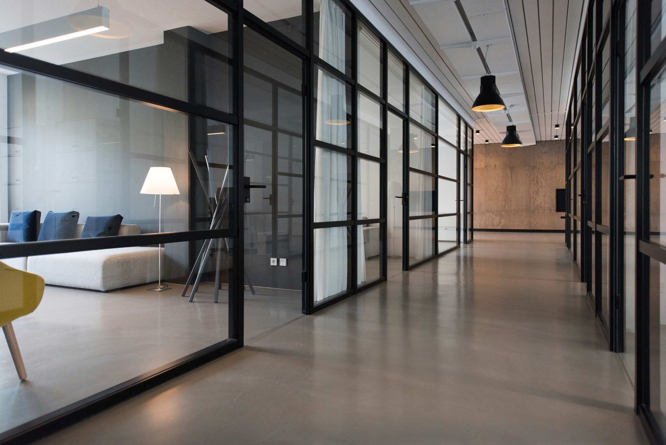 An office hallway with glass windows